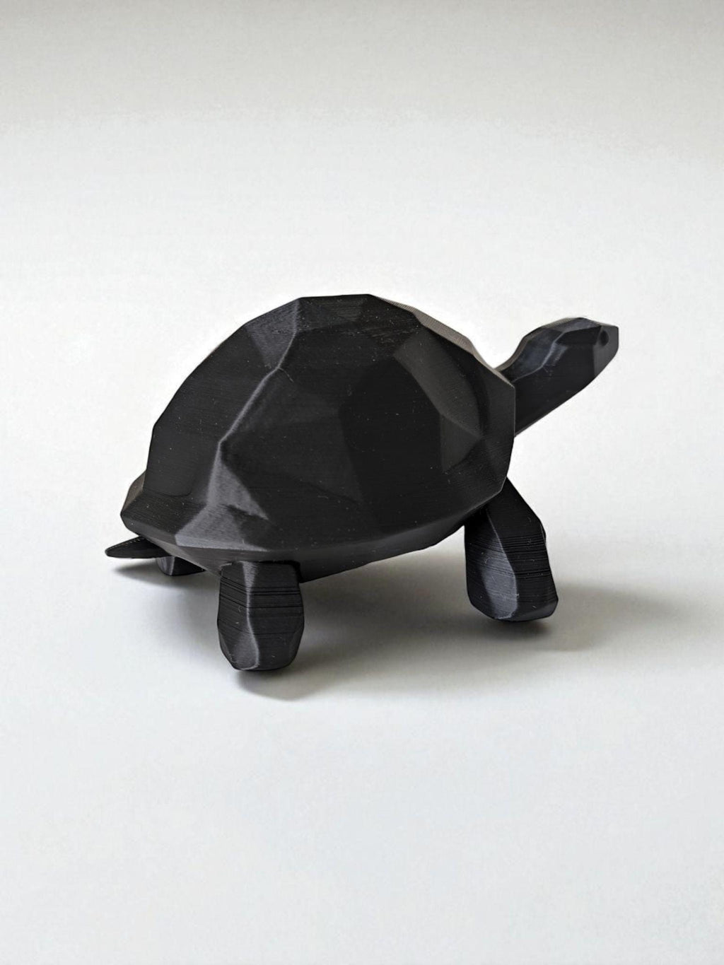 A modern low-poly walking turtle — minimalist design meets nature’s charm.